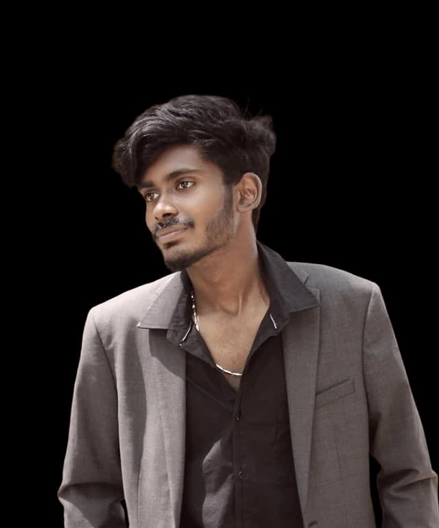 Baskar J, photographed in a blazer against the Abrix red panel